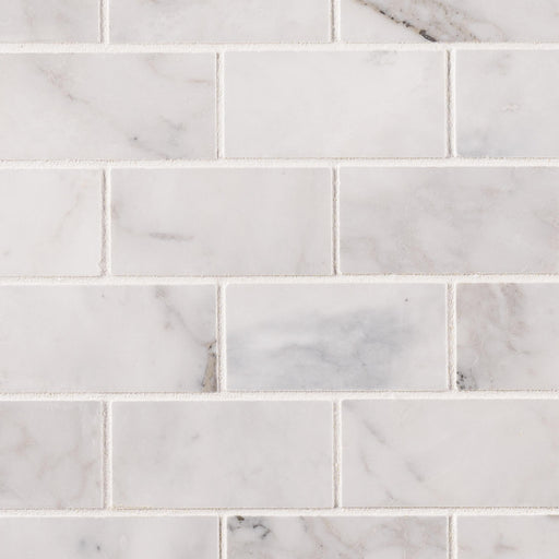 Calacatta Cressa 2x4 honed marble subway mosaic tile with gray and beige veining in a staggered brick pattern.