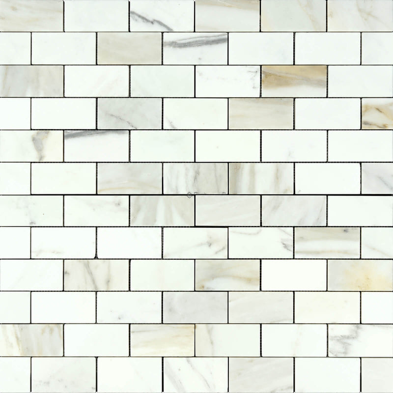 Calacatta Gold 2x4 polished marble mosaic tile with white rectangular pieces and soft gray and gold veining in a staggered brick pattern.