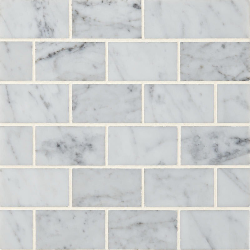 Carrara White 2x4 polished marble mosaic tile with gray veining in a staggered brick pattern.