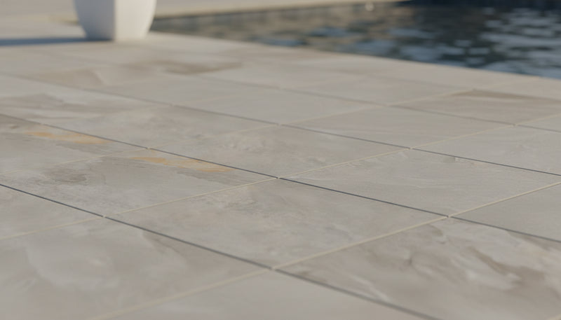 Close-up of Silver Travertine Tumbled 24 x 24 x 2 4-SIDED Modern Coping, in Silver tones.