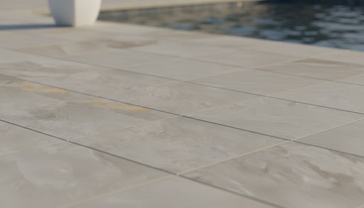 Close-up of Silver Travertine Tumbled 24 x 24 x 2 4-SIDED Modern Coping, in Silver tones.
