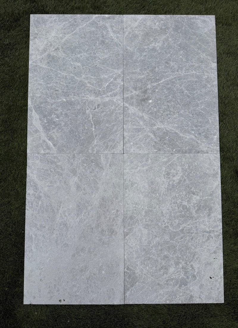 Close-up of Tundra Marble Leather (Sandblasted & Brushed) 16 x 24 x 2 4-SIDED Modern Coping, in Tundra tones.