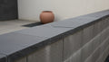Close-up of Indian Black Limestone Natural 24 x 24 x 2 Limestone Column Cap Cap, in Indian Black tones.