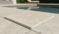 Close-up of Ivory Cordoba Cream Travertine Tumbled 24 x 24 x 2 4-SIDED Modern Coping, in Ivory tones.
