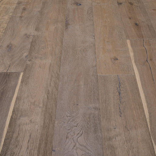 Composer Strauss European oak flooring with wide warm brown planks, visible knots and natural grain in an installed floor detail.