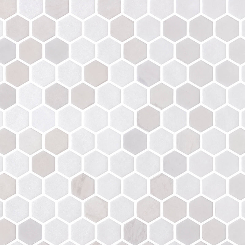 Cosmos Glass Blend Blanco 1.25-inch mesh-mounted hexagon mosaic with white and pale gray tiles.