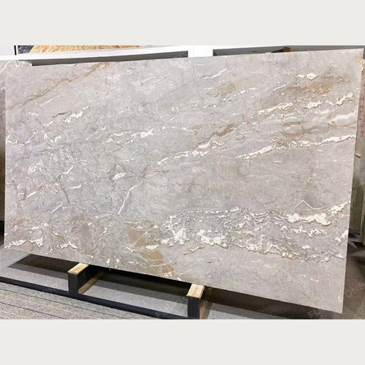 Full Dolce Vita quartzite slab with a soft gray surface, flowing white veins, and subtle beige mineral patterns.