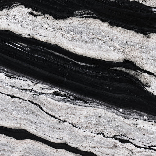 Eclipse polished granite with flowing black bands and pale gray crystalline layers.