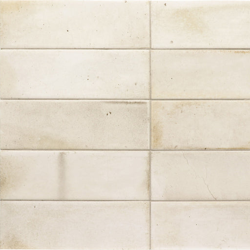 Equipe Hanoi White 2x6 matte ceramic tiles with warm white tones, subtle mottling and small speckles in a stacked layout.