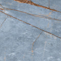 Close-up of Florim Heritage Azure glossy porcelain slab with pale blue tones and copper-brown veining.