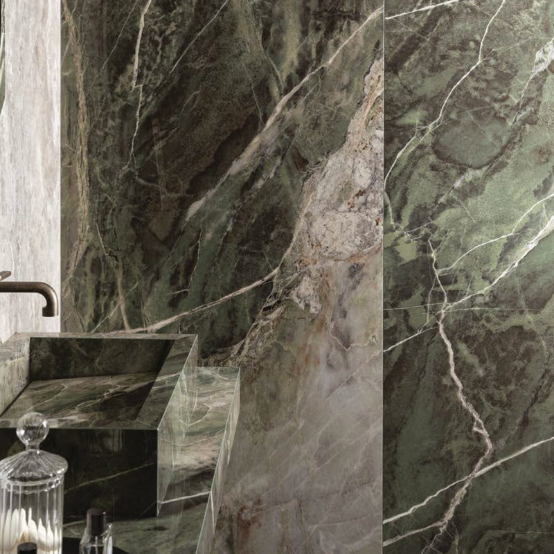 Florim Program Heritage Emerald 47x110 glossy 6mm porcelain slab on bathroom walls with a matching green veined washbasin.