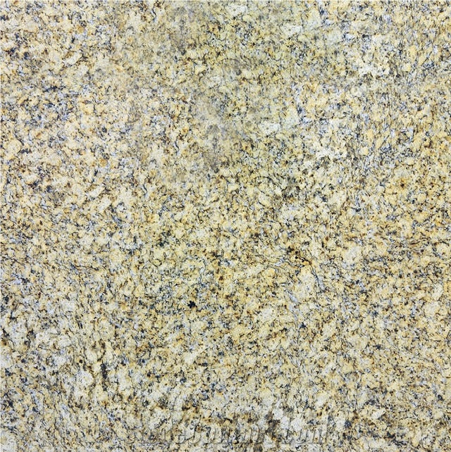 Close-up of Giallo Napoli granite with cream and golden tones and dark mineral speckles.