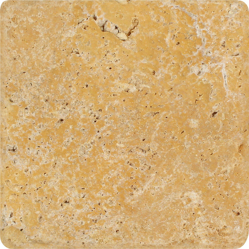 Golden Sienna tumbled travertine tile with warm golden color, natural pits, and softly rounded edges.