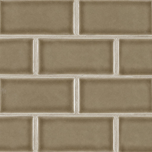Glossy taupe 3x6 ceramic subway tiles with subtle crackle texture in a staggered pattern.