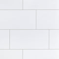 Iceland White 12x24 porcelain wall tiles in a staggered layout with thin light-gray grout lines.