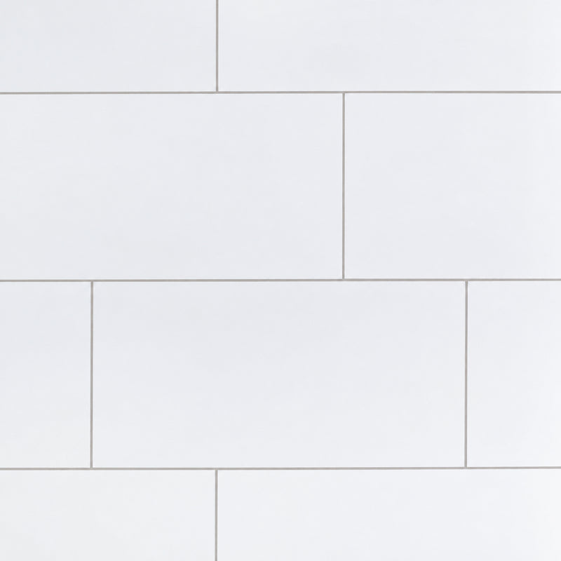 Iceland White 12x24 porcelain wall tiles in a staggered layout with thin light-gray grout lines.