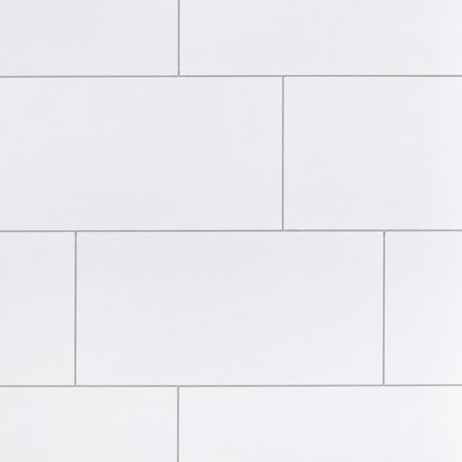 Iceland White 12x24 porcelain wall tiles in a staggered layout with thin light-gray grout lines.