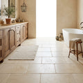 Ivory / Light Travertine 16x24 Cream Tumbled Tile — Primary Bath floor