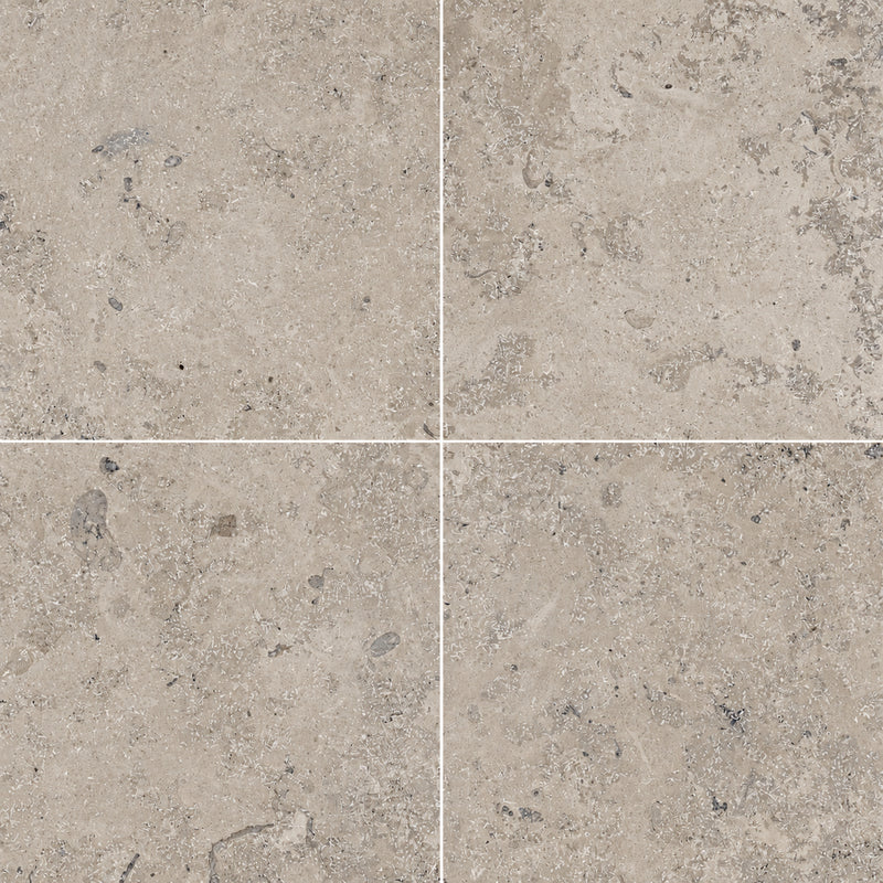 Jura Grey 24x24x0.56 honed limestone tiles with warm gray-beige tones and natural fossil markings in a four-tile layout.