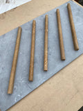 Close-up of Noce Toros Travertine Unfilled & Honed 1/2 x 12 Needle Tile, in Noce tones.