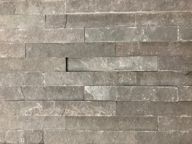 Close-up of Natural Stone INDIAN(LIME) Black Split Face 6 x 24 Flat Panel Stone Veneer, in Natural tones.