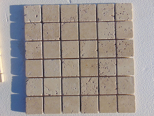 Close-up of Ivory Cordoba Cream Travertine Tumbled 2 x 2 Mosaic, in Ivory tones.