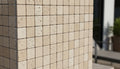 Close-up of Ivory Cordoba Cream Travertine Tumbled 2 x 2 Mosaic, in Ivory tones.