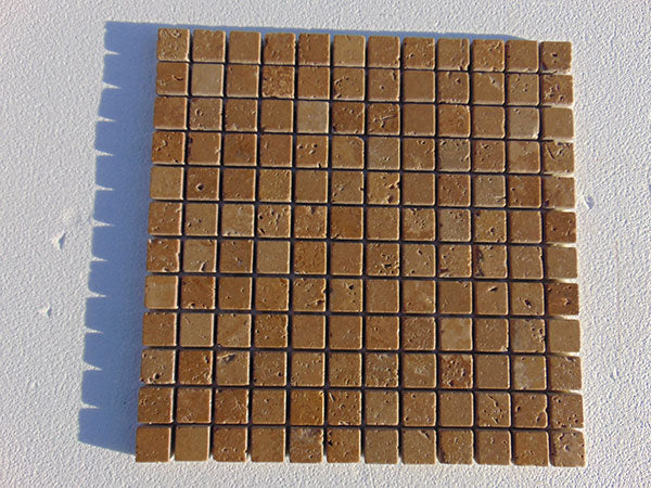 Close-up of Noce Toros Travertine Tumbled 1 x 1 Mosaic, in Noce tones.