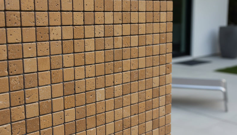 Close-up of Noce Toros Travertine Tumbled 1 x 1 Mosaic, in Noce tones.
