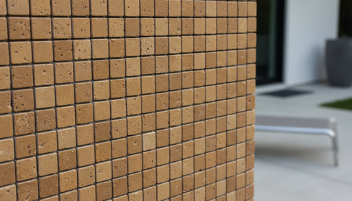 Close-up of Noce Toros Travertine Tumbled 1 x 1 Mosaic, in Noce tones.