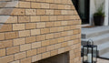 Close-up of Noce Toros Travertine Tumbled 1 x 2 Mosaic, in Noce tones.