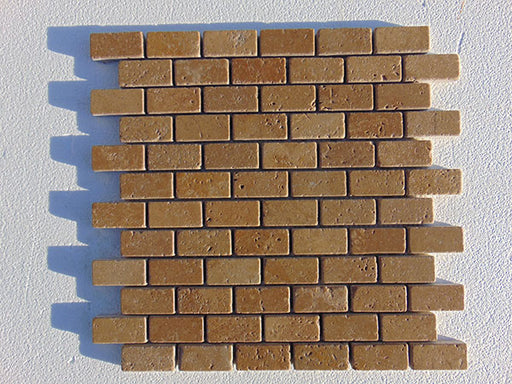 Close-up of Noce Toros Travertine Split Face 1 x 2 Mosaic, in Noce tones.