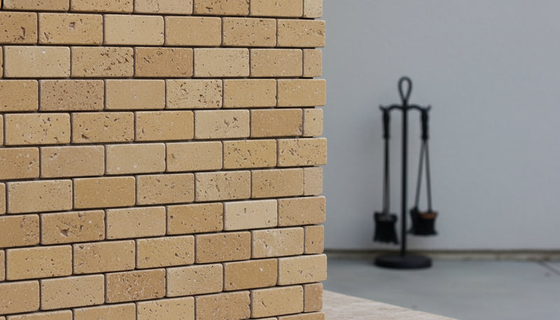 Close-up of Noce Toros Travertine Split Face 1 x 2 Mosaic, in Noce tones.
