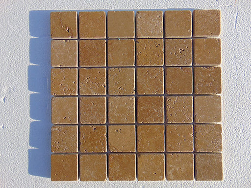 Close-up of Noce Toros Travertine Tumbled 2 x 2 Mosaic, in Noce tones.