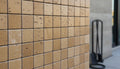Close-up of Noce Toros Travertine Tumbled 2 x 2 Mosaic, in Noce tones.