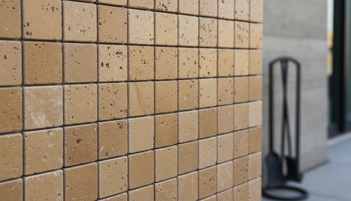 Close-up of Noce Toros Travertine Tumbled 2 x 2 Mosaic, in Noce tones.