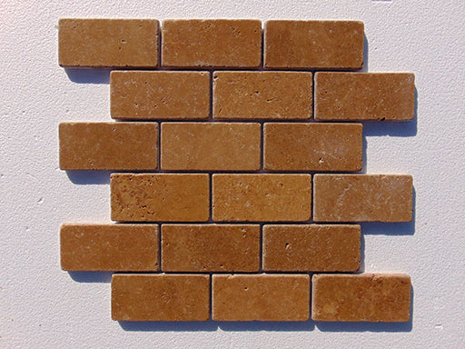 Close-up of Noce Toros Travertine Tumbled 2 x 4 Mosaic, in Noce tones.