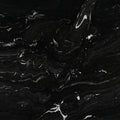 Makalu 2cm polished granite slab showing a black surface with flowing white and gray veining.