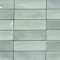 Mayolica Beret Tea 2x6 glossy ceramic tiles with pale green tones and a stacked rectangular layout.