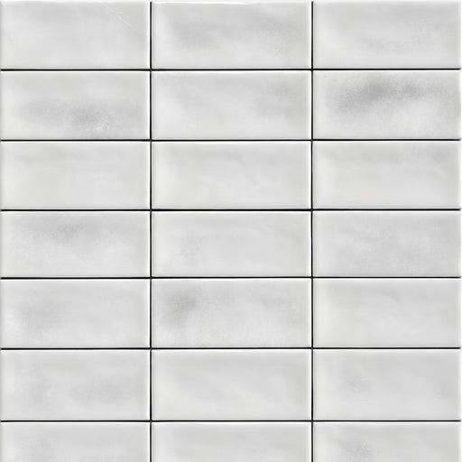 White glossy ceramic tiles arranged in a staggered brick pattern.