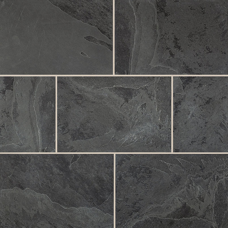 Montauk Black slate pavers in a staggered layout with charcoal-gray textured surfaces and narrow beige joints.