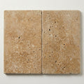 Noce Travertine Coping 16x24 Tumbled Bullnose, Brown 1.25 inch close-up