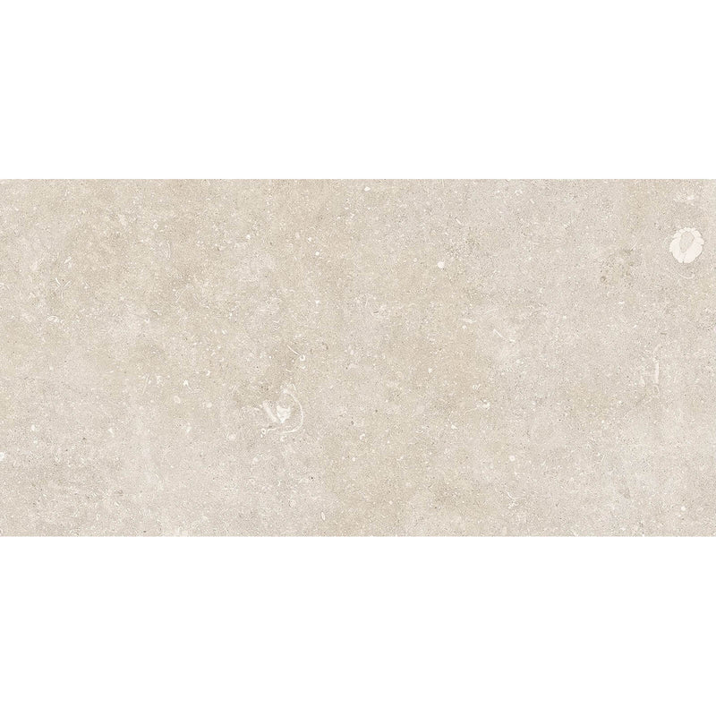 Oda Light 48x24 soft textured tile with warm beige stone patterns, delicate speckling and pale fossil-like details.
