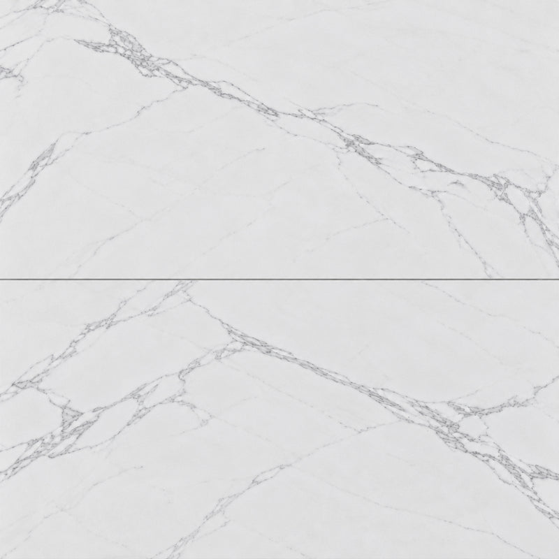 Close-up of Omnia Calacatta 12x24 matte marble look porcelain tiles with delicate gray veining and narrow grout joints.