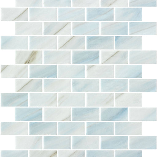 Onix Glass Brick Zhoe glossy glass mosaic with staggered 1x2 rectangular pieces in pale blue and white with delicate veining.