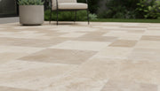 Close-up of Ivory Cordoba Cream Travertine Tumbled French Versailles x 1.25 Paver, in Ivory tones.