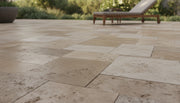 Close-up of Chocolate Brown Walnut Travertine Tumbled French Versailles x 1.25 Paver, in Brown tones.