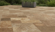 Close-up of Chocolate Brown Walnut Travertine Tumbled Roman Pattern Paver, in Brown tones.