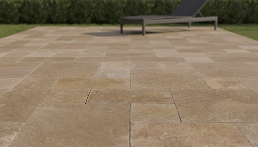 Close-up of Noce Travertine Tumbled Roman x 1.25 Paver, in Noce tones.