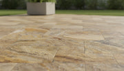 Close-up of Autumn Leaves Scabos Travertine Tumbled Roman x 1.25 Paver, in Autumn tones.